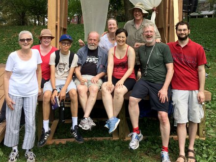 Nine Coriolanus cast members getting a group photo in Clark Park.